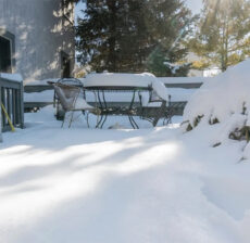 A picture of a deck covered in snow.