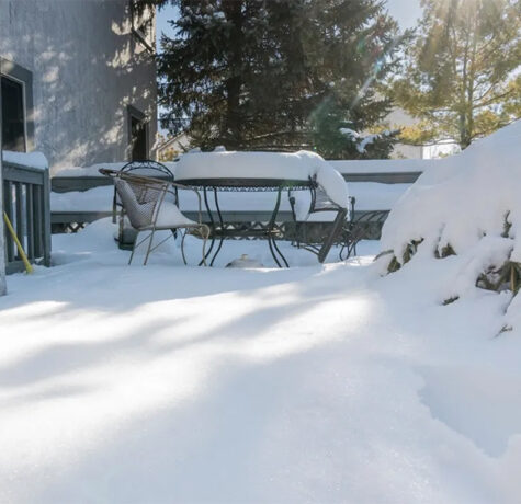 A picture of a deck covered in snow.