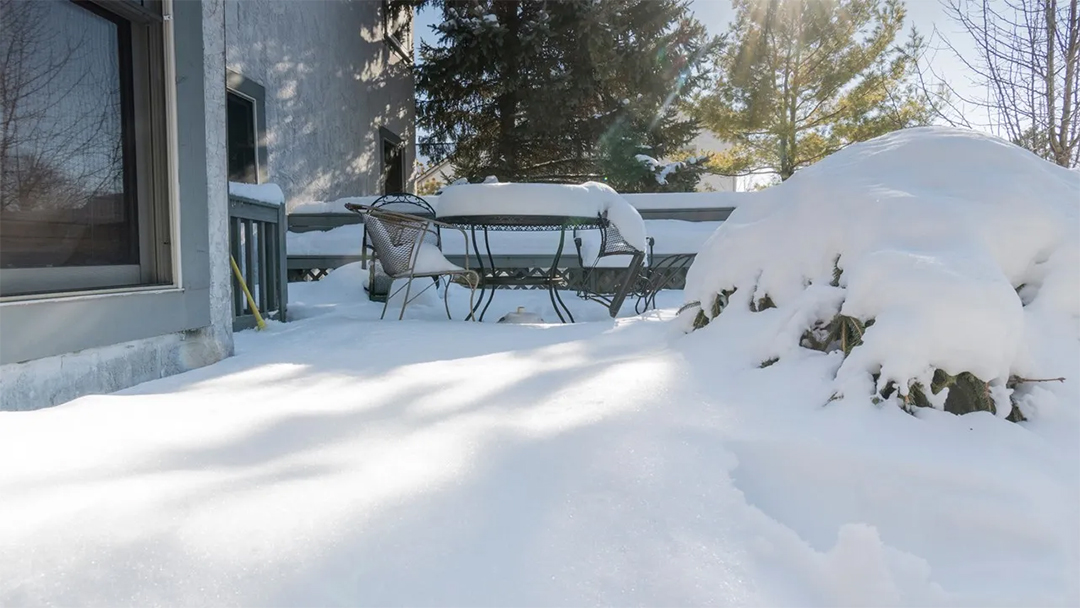 A picture of a deck covered in snow.